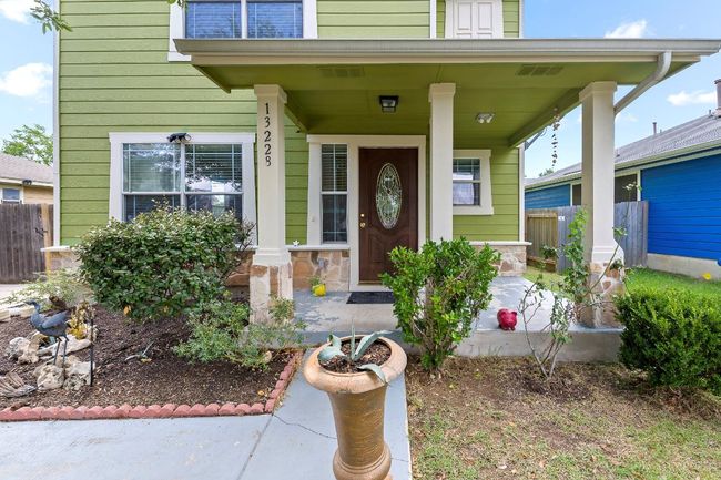 Doorway to property with covered porch and stone siding | Image 5