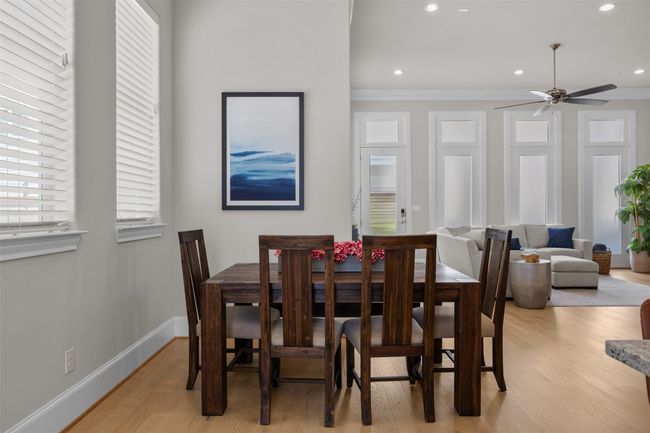 Dining room featuring a ceiling fan, light wood finished floors, crown molding, and recessed lighting | Image 11