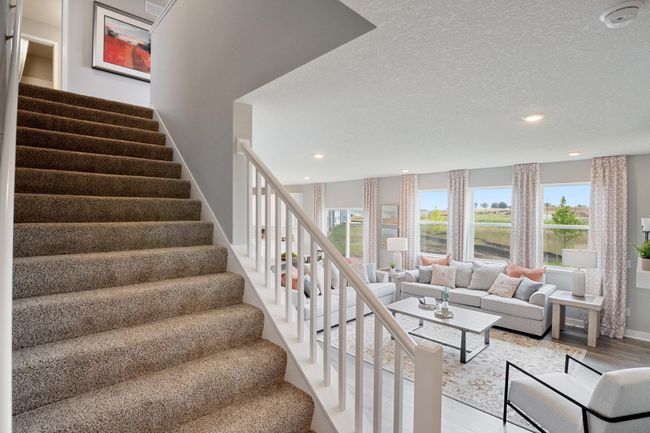 Wide staircase leading to the 4 upper-level bedrooms, loft and laundry. Model photo. Options and colors will vary. | Image 9