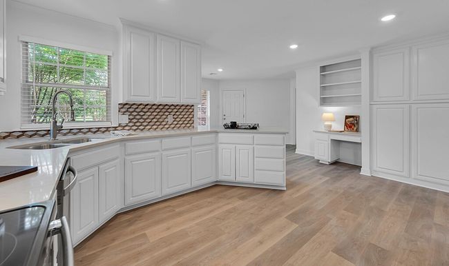Kitchen featuring backsplash, a sink, white cabinets, and recessed lighting | Image 12