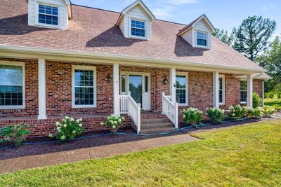 Fresh landscaping and exterior trim paint have this home looking gorgeous. (Note blue sprinkler hose is temporary) | Image 2