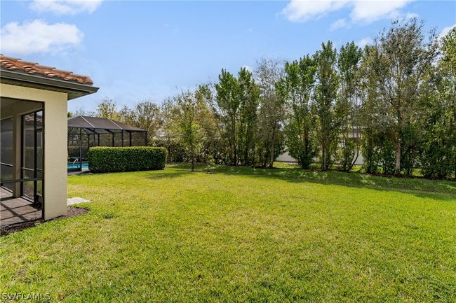 View of yard with a swimming pool and a lanai | Image 29