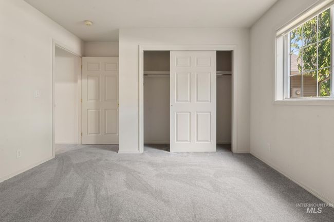 Unfurnished bedroom with carpet floors and a closet | Image 15