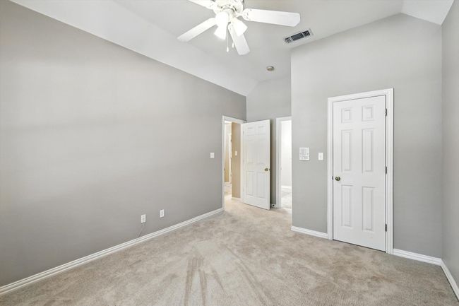 bedroom featuring carpet floors, high vaulted ceiling, and a ceiling fan | Image 15