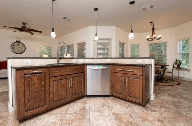 Stainless appliances in this easy-flow kitchen. Pull out trash cabinet next to sink! | Image 9