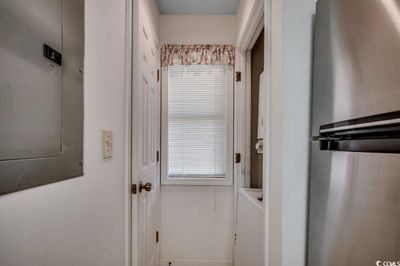 Interior space with washer / clothes dryer and stainless steel refrigerator | Image 2