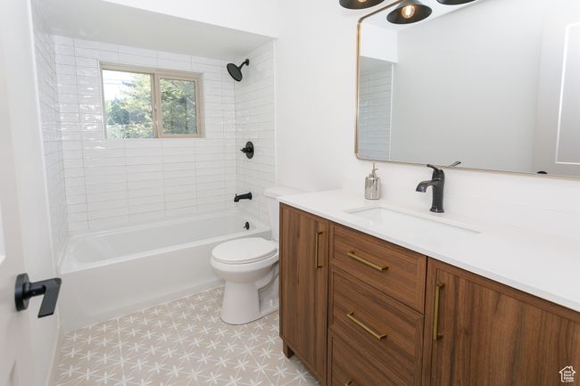 Full bath with vanity, toilet, bathing tub / shower combination, and tile patterned floors | Image 7