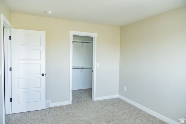 Unfurnished bedroom with carpet, a spacious closet, and a closet | Image 30