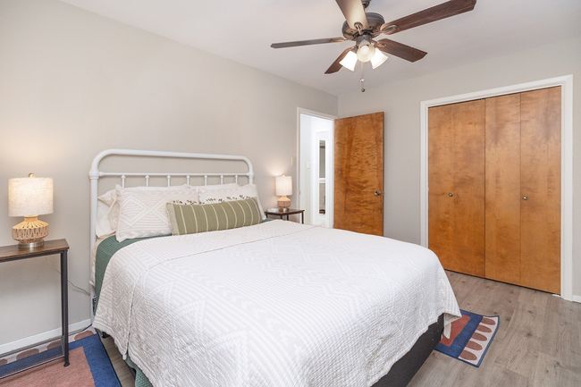 Bedroom with wood finished floors, a closet, and a ceiling fan | Image 27