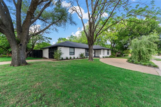 View of front of property featuring concrete driveway, a front lawn, a garage, and a shingled roof | Image 19