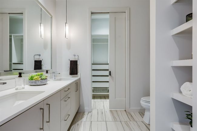 Built-in cubbies for towels and toiletries keep everything in place, ensuring the space feels tidy and organized without the need for extra storage | Image 25