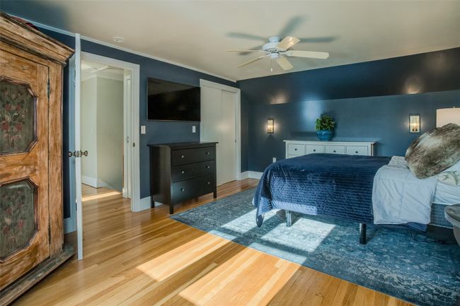 Bedroom with light wood-type flooring, ceiling fan, and crown molding | Image 19