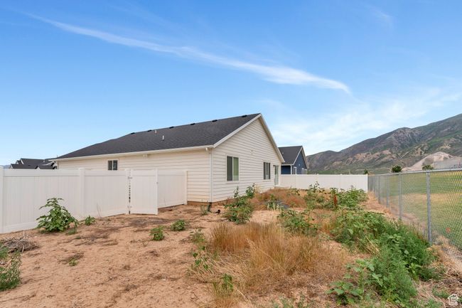 Back of property with a mountain view and a fenced backyard | Image 27