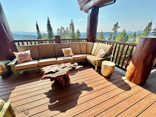 Outside wrap around deck sitting area with summer views. | Image 84