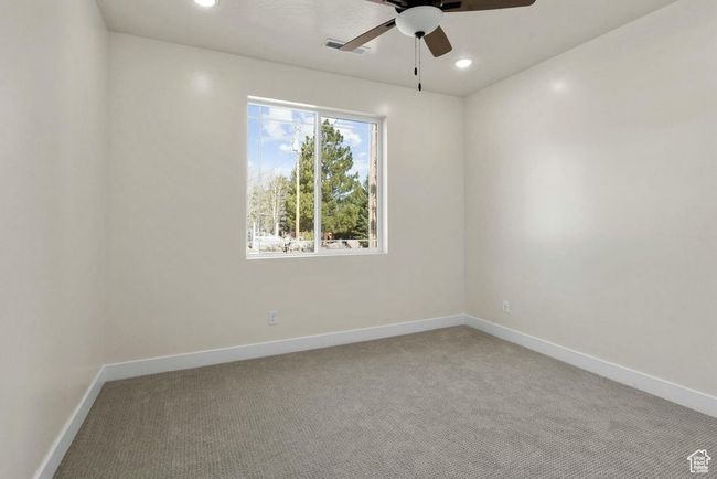 Empty room featuring carpet floors, visible vents, a ceiling fan, and baseboards | Image 15