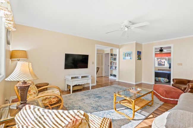 Living room featuring light hardwood / wood-style flooring and crown molding | Image 10