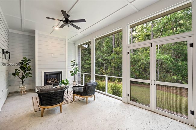 Rear Screened Porch with Gas Fireplace & TV ready above | Image 28
