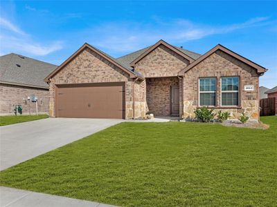 View of front of property with a front lawn and a garage - grass is digitally enhanced | Image 2