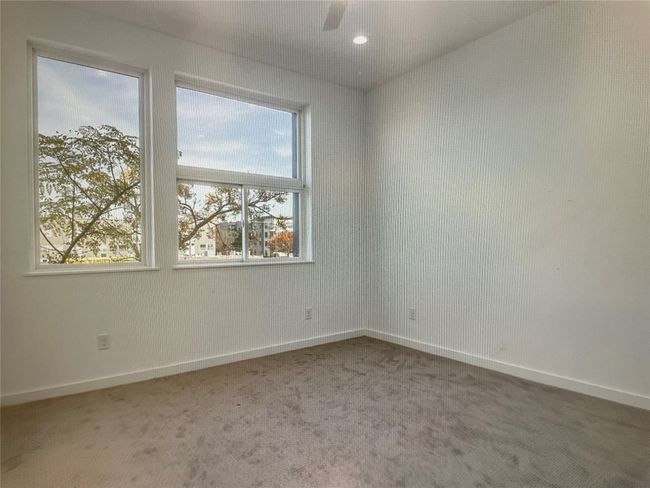 Carpeted spare room featuring a ceiling fan, baseboards, and recessed lighting | Image 8