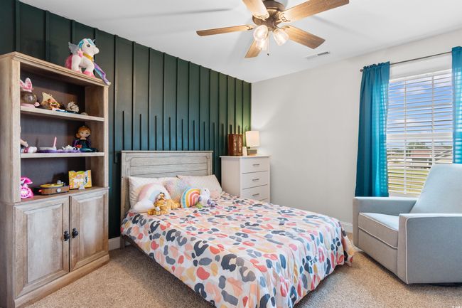 Bedroom with light carpet and a ceiling fan | Image 21