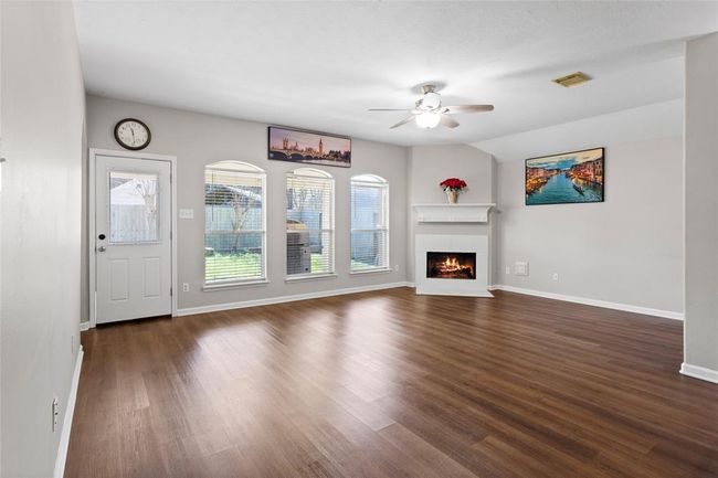 The beautiful focal points in the Living Area are the gas fireplace, the large arched windows and the rounded corners. | Image 4