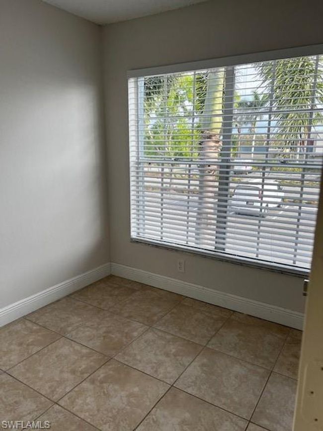 Spare room with baseboards, light tile patterned floors, and a wealth of natural light | Image 8