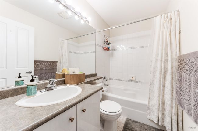 Full bathroom featuring shower / bath combo, vanity, and toilet | Image 13