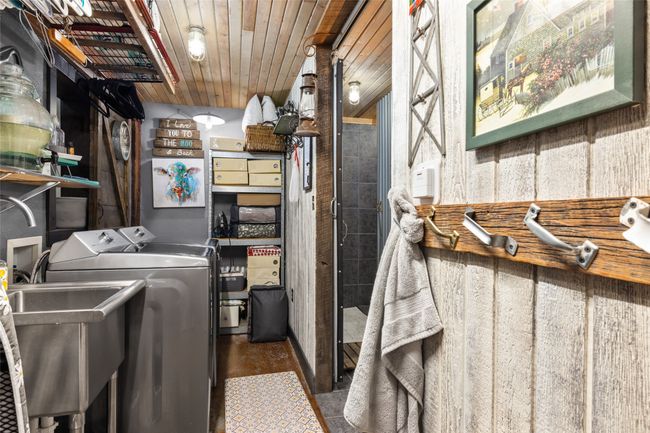 Laundry area featuring separate washer and dryer and wood ceiling | Image 33