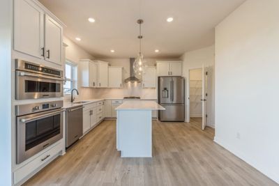 Photo is of the actual home. Thoughtfully-designed with a combination of functionality and modern design, this kitchen space is sure to impress. | Image 3