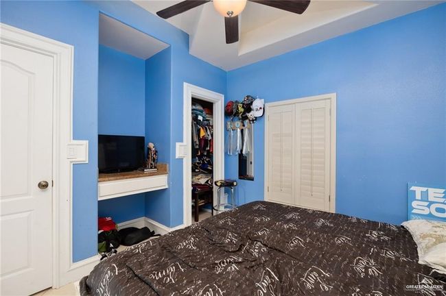 Bedroom featuring ceiling fan | Image 8