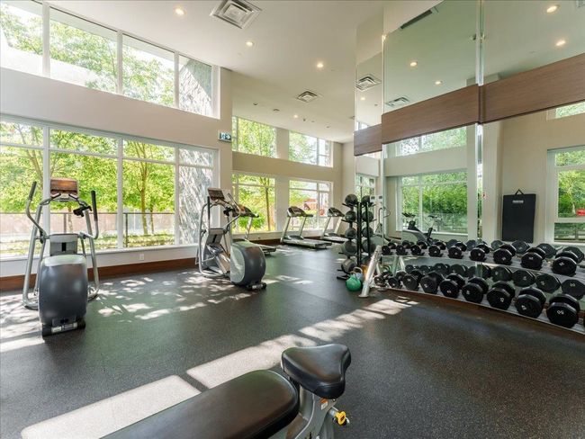 Workout area with a towering ceiling and recessed lighting | Image 34