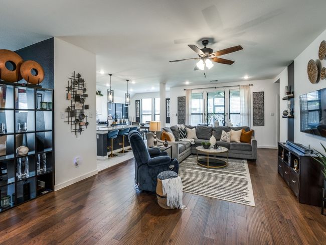Living area with baseboards, ceiling fan, and dark wood-style flooring | Image 11