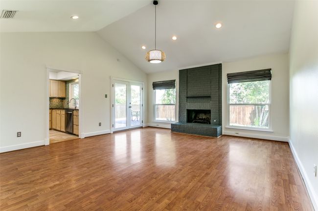 Living room with gas fireplace, vaulted ceiling and gas fireplace. | Image 8