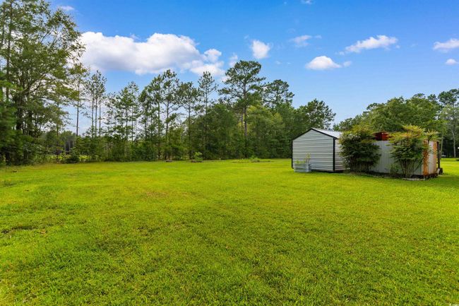 View of grassy yard featuring a shed | Image 26