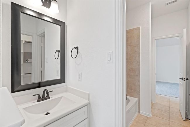 This spacious bedroom features a bright window for natural light, a high sloped ceiling, and a ceiling fan for added comfort and air circulation. *Virtually Staged* | Image 17