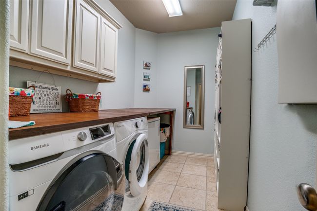 Large laundry room with plenty of storage and working space | Image 26