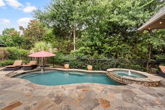 Enjoy the view from this lovely terraced stone patio of the greenbelt nature preserve, heated pool and spa | Image 35