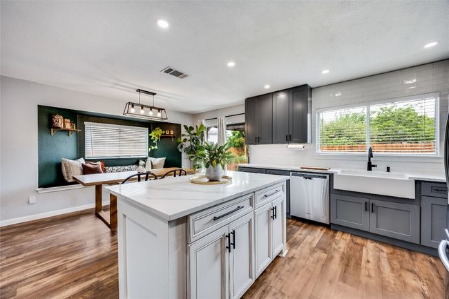Kitchen featuring stainless steel dishwasher, a sink, light wood-style floors, decorative backsplash, and recessed lighting | Image 12