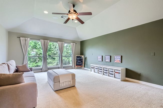 Expansive upstairs retreat overlooking the backyard—ideal for movie nights or playtime | Image 24