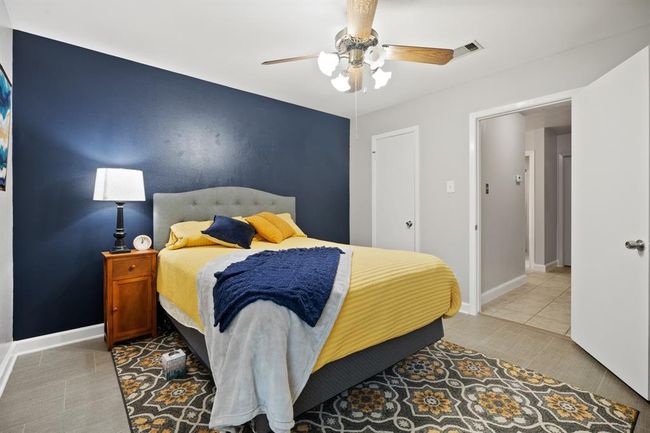 Secondary bedroom with walk-in closet and ceiling fan. | Image 25