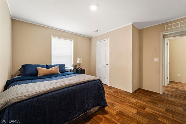 Bedroom with crown molding and dark wood-type flooring | Image 20