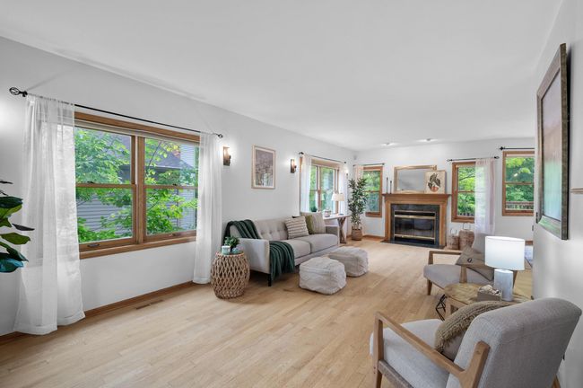 The living room’s fireplace and natural light make it the ultimate retreat. | Image 7