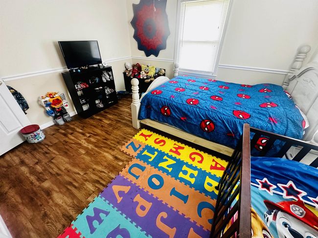 Bedroom with wood finished floors | Image 12