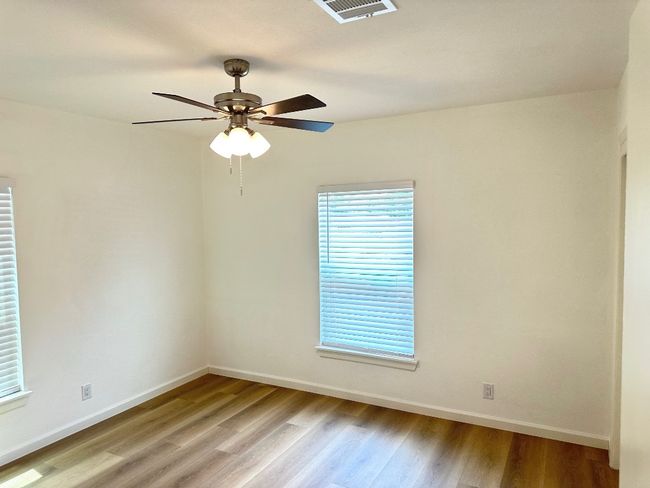 Empty room featuring light wood-type flooring, baseboards, and ceiling fan | Image 15