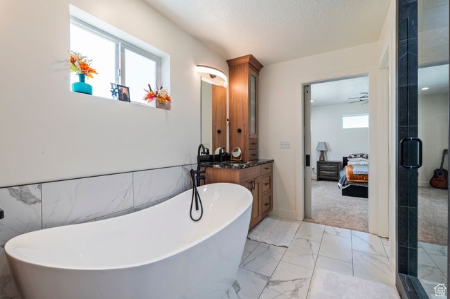 Bathroom with marble finish floor, connected bathroom, vanity, and a stall shower | Image 23