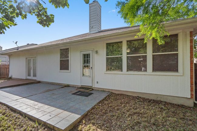Rear view of house with a chimney, a patio area, and french doors | Image 33