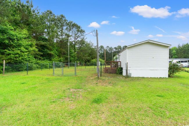 View of yard featuring a gate | Image 22