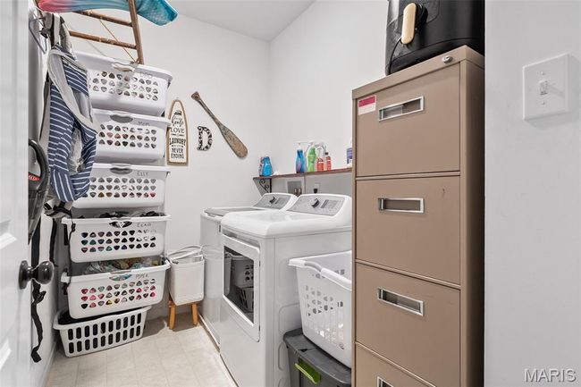 Laundry room featuring washing machine and clothes dryer | Image 25