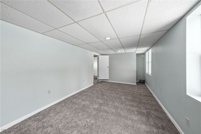 Basement with carpet floors and a paneled ceiling | Image 30