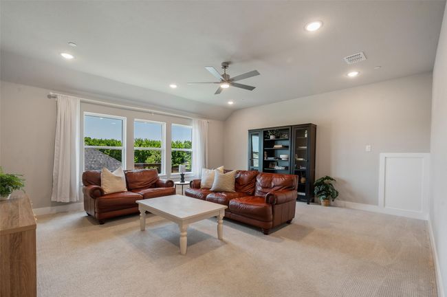 Large upstairs living room with 3 large windows and nice fan. | Image 25